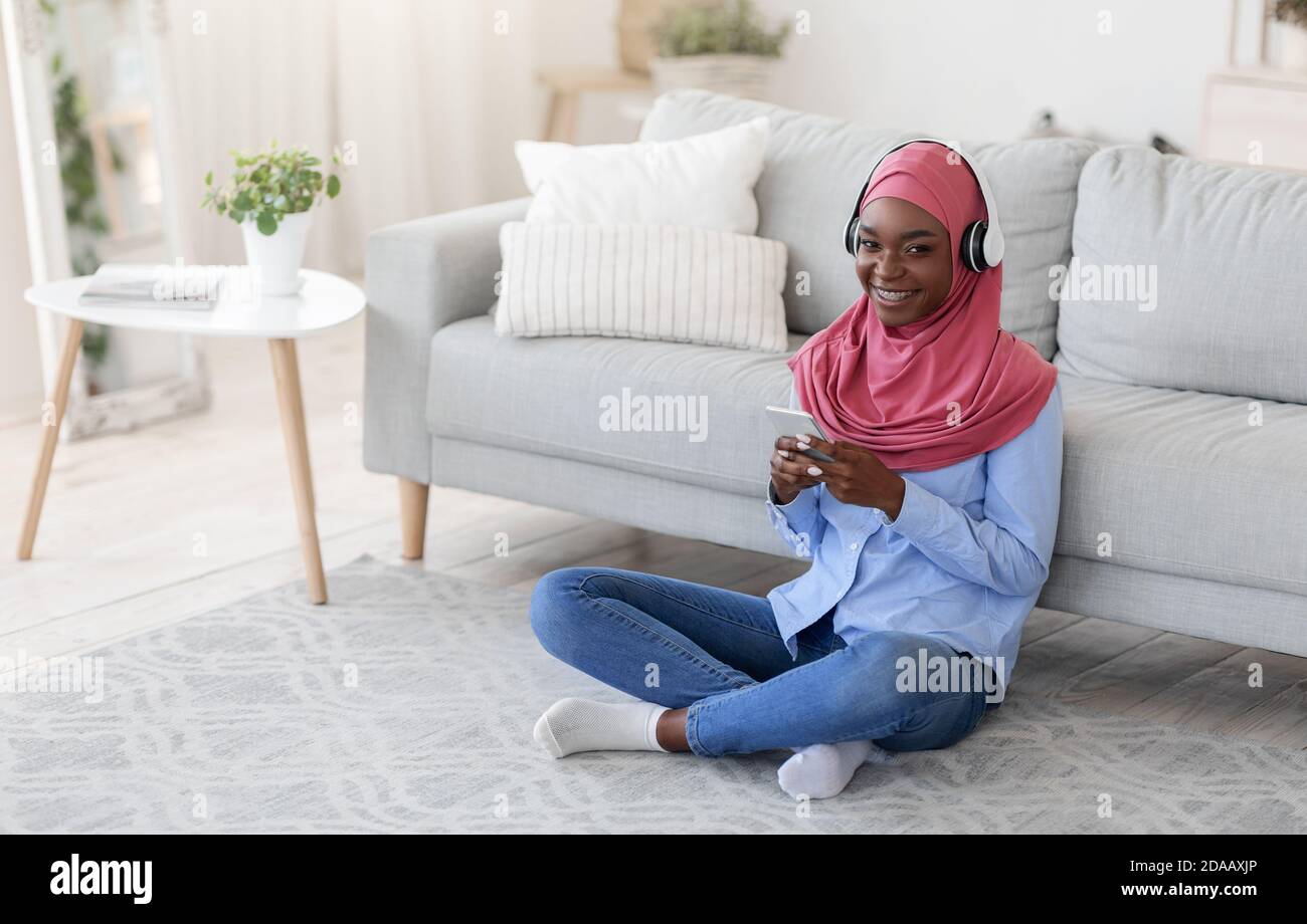 Stay At Home. Smiling Black Muslim Woman Relaxing With Smartphone And ...