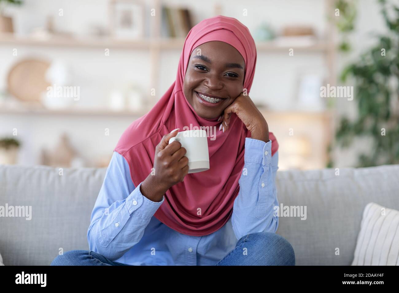 Relaxing Drink. Smiling Black Muslim Lady In Hijab Drinking Coffee At ...