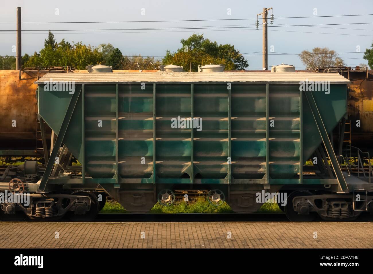 Old rusty cargo train wagon on the rail road tracks on a sunny day Stock Photo