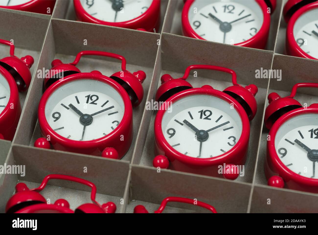 Colored clock alarm clocks in a cardboard box Stock Photo Alamy