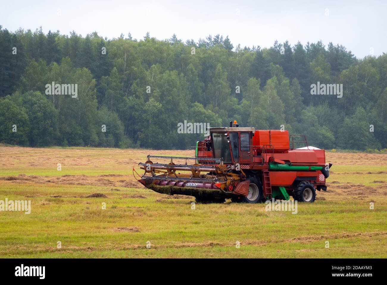 Heavy duty farm equipment in the field. Big combine harvester vehicle