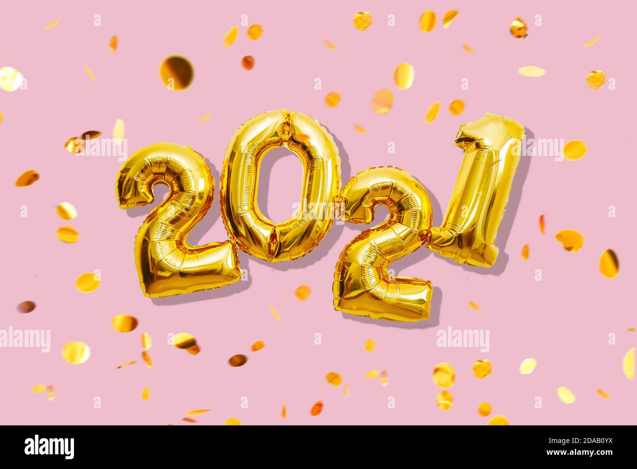 Gold shiny numbers 2021 with multicolored confetti, happy new year concept Stock Photo