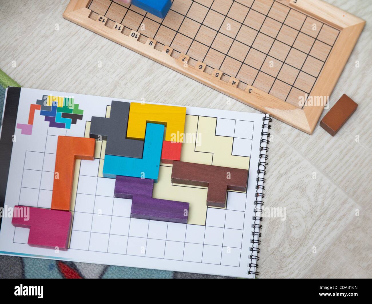 Children play a Board game. Educational games for children. the children  put the colored blocks to fill all empty cells Stock Photo - Alamy