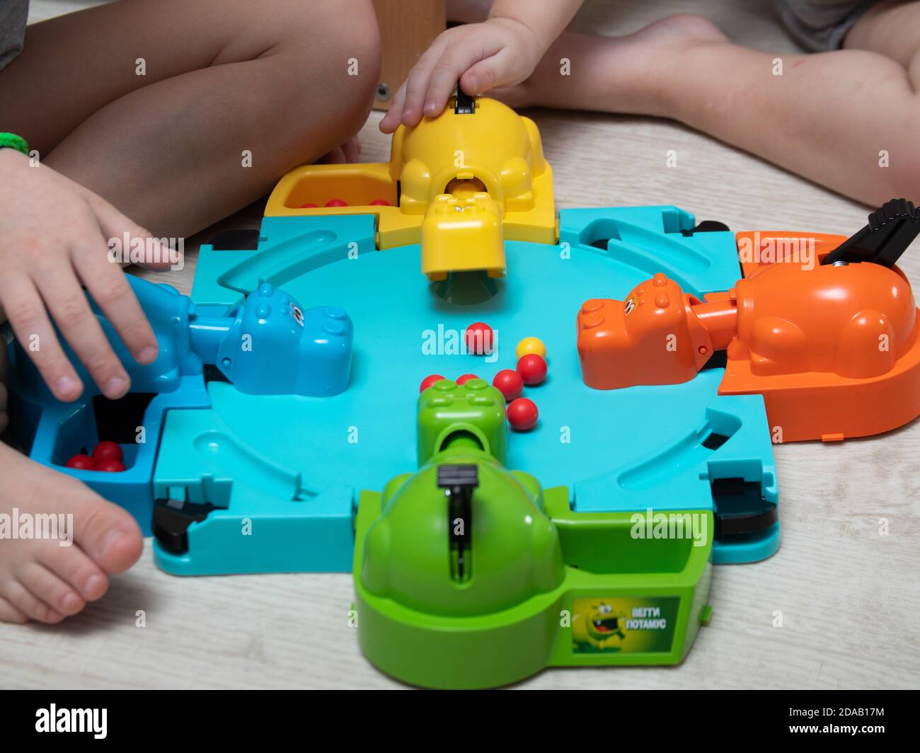 Children play a fun Board game where hippos eat balls. reaction games