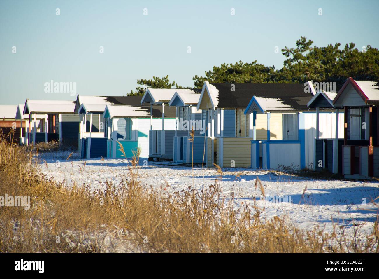 Candy coloured beach hut decorating the snowy beach of Skanor in south of Sweden Stock Photo
