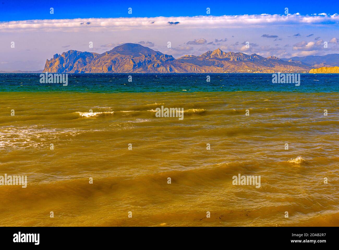 Resort place on The black sea coast in the Crimea Ordzhonikidze, the sea is stormy, so the water near the shore, where it is shallow, mixed with sand Stock Photo