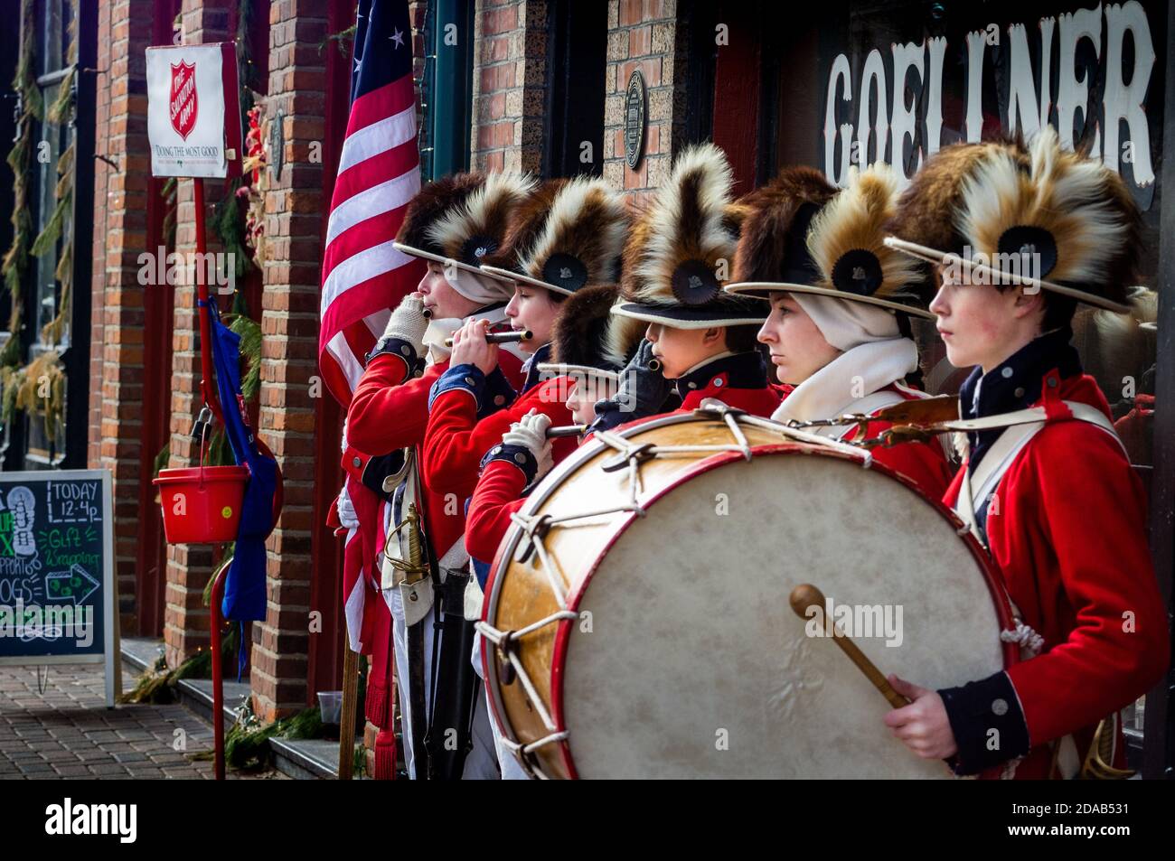 Saint Charles, MO--Dec 19, 2018; Salvation Army actors recreate historic Fife and Drum corp band in colonial dress near collection kettle. Stock Photo