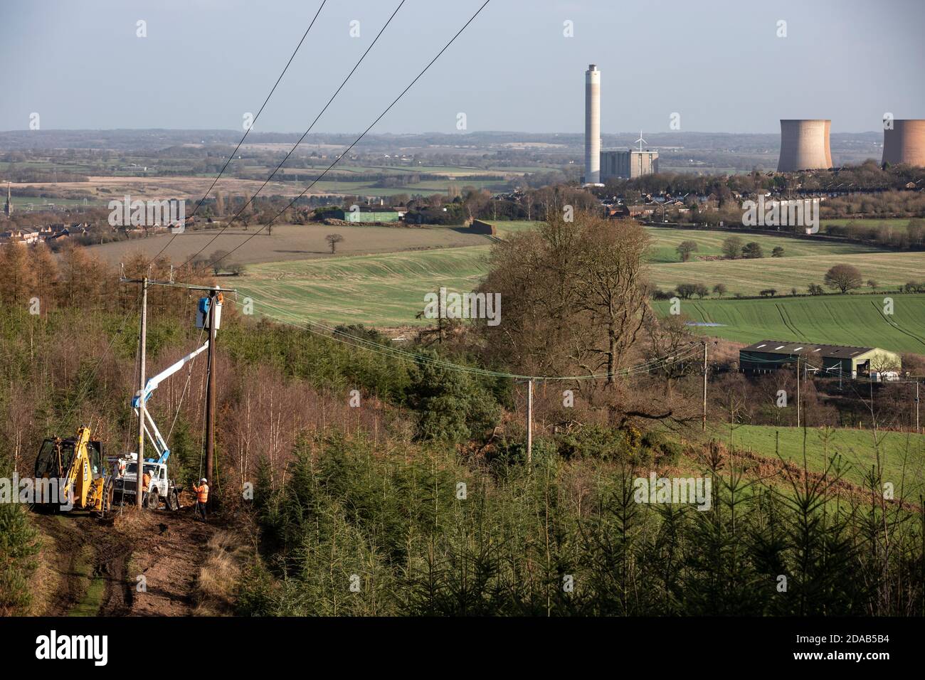 Rugeley Power Station in Staffordshire on the horizon with Electricity Power workers in the foreground on the edge of Cannock Chase Stock Photo