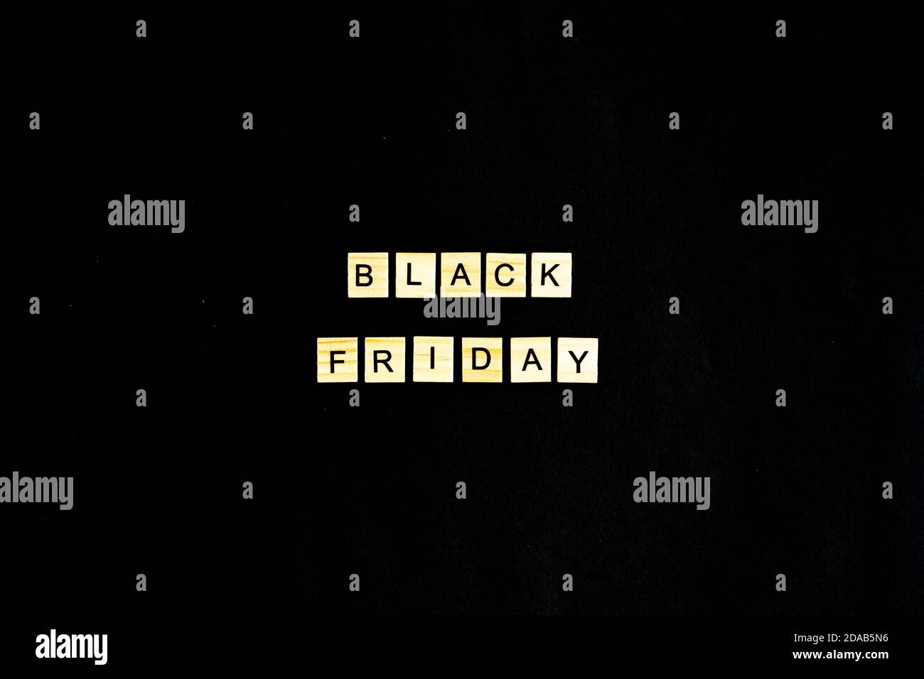 Black Friday written in wooden letters on a black background, sales, holiday sales, top view, flat layout, price reduction Stock Photo