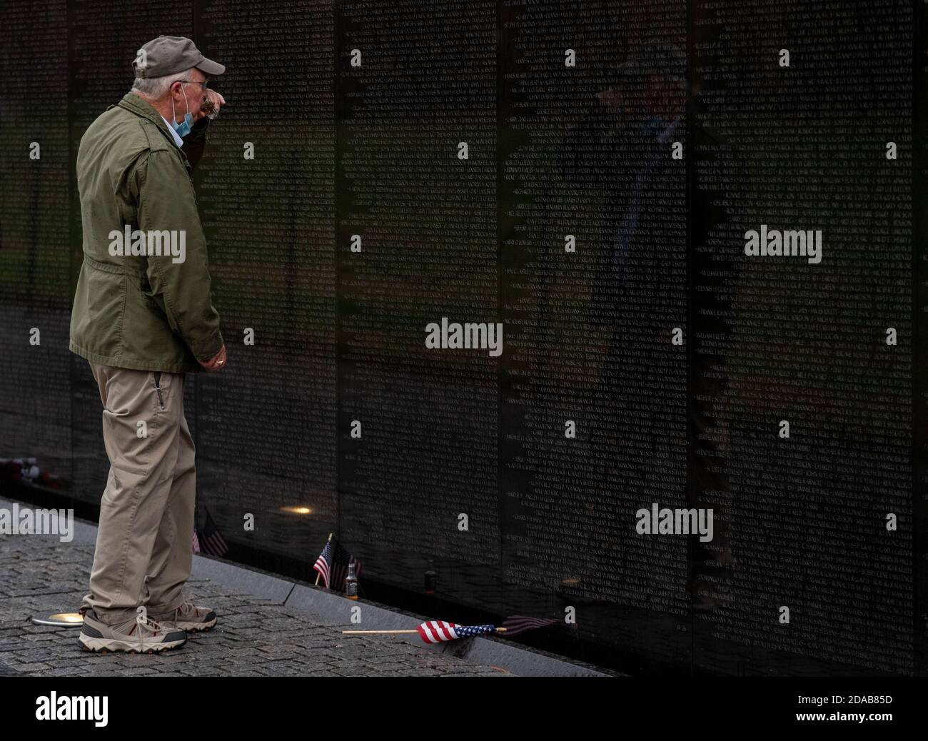 Washington, United States. 11th Nov, 2020. Jack Cowling, a Marine Corp veteran, HMM 364, does a shot of Jack Daniels as he visits the site of his good buddy Staff Sergeant Barney Barnhart at the Vietnam Memorial on Veterans Day in Washington, DC on Wednesday, November 11, 2020. Cowling does a shot of Jack Daniels and leaves another shot for his friend at the site every year. Veterans Day is a federal holiday in the United States observed annually on November 11, for honoring military veterans who have served in the United States Armed Forces. Photo by Ken Cedeno/UPI Stock Photo