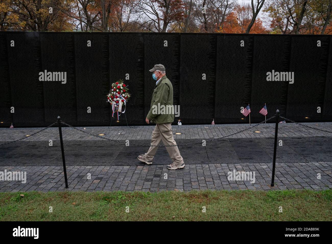 Washington, United States. 11th Nov, 2020. Jack Cowling, a Marine Corp veteran, HMM 364, walks to visit the site of his good buddy Staff Sergeant Barney Barnhart at the Vietnam Memorial on Veterans Day in Washington, DC on Wednesday, November 11, 2020. Cowling does a shot of Jack Daniels and leaves another shot for his friend at the site every year. Veterans Day is a federal holiday in the United States observed annually on November 11, for honoring military veterans who have served in the United States Armed Forces. Photo by Ken Cedeno/UPI Credit: UPI/Alamy Live News Stock Photo