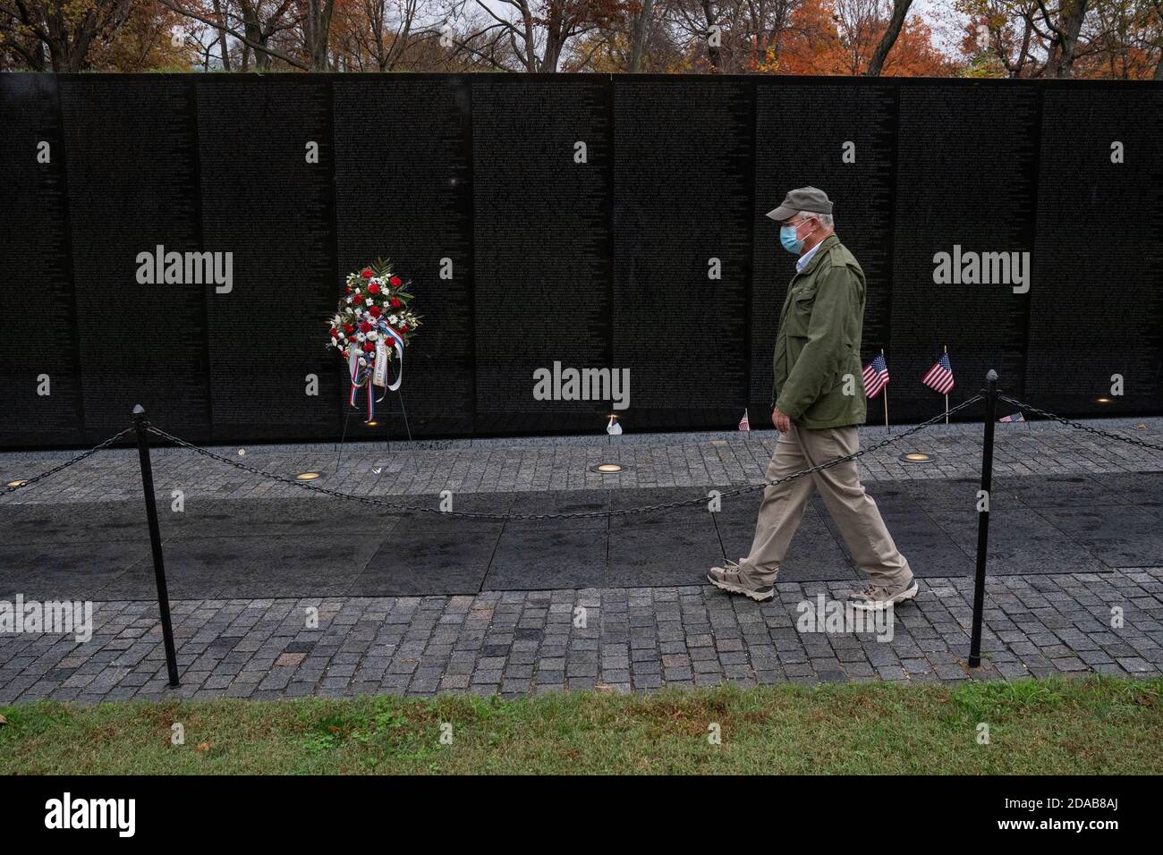Washington, United States. 11th Nov, 2020. Jack Cowling, a Marine Corp veteran, HMM 364, walks to visit the site of his good buddy Staff Sergeant Barney Barnhart at the Vietnam Memorial on Veterans Day in Washington, DC on Wednesday, November 11, 2020. Cowling does a shot of Jack Daniels and leaves another shot for his friend at the site every year. Veterans Day is a federal holiday in the United States observed annually on November 11, for honoring military veterans who have served in the United States Armed Forces. Photo by Ken Cedeno/UPI Credit: UPI/Alamy Live News Stock Photo