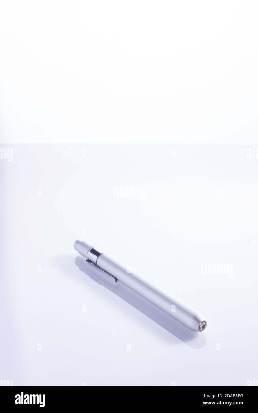 medical flashlight for examination on a white background Medical diagnostic pen light with pupil