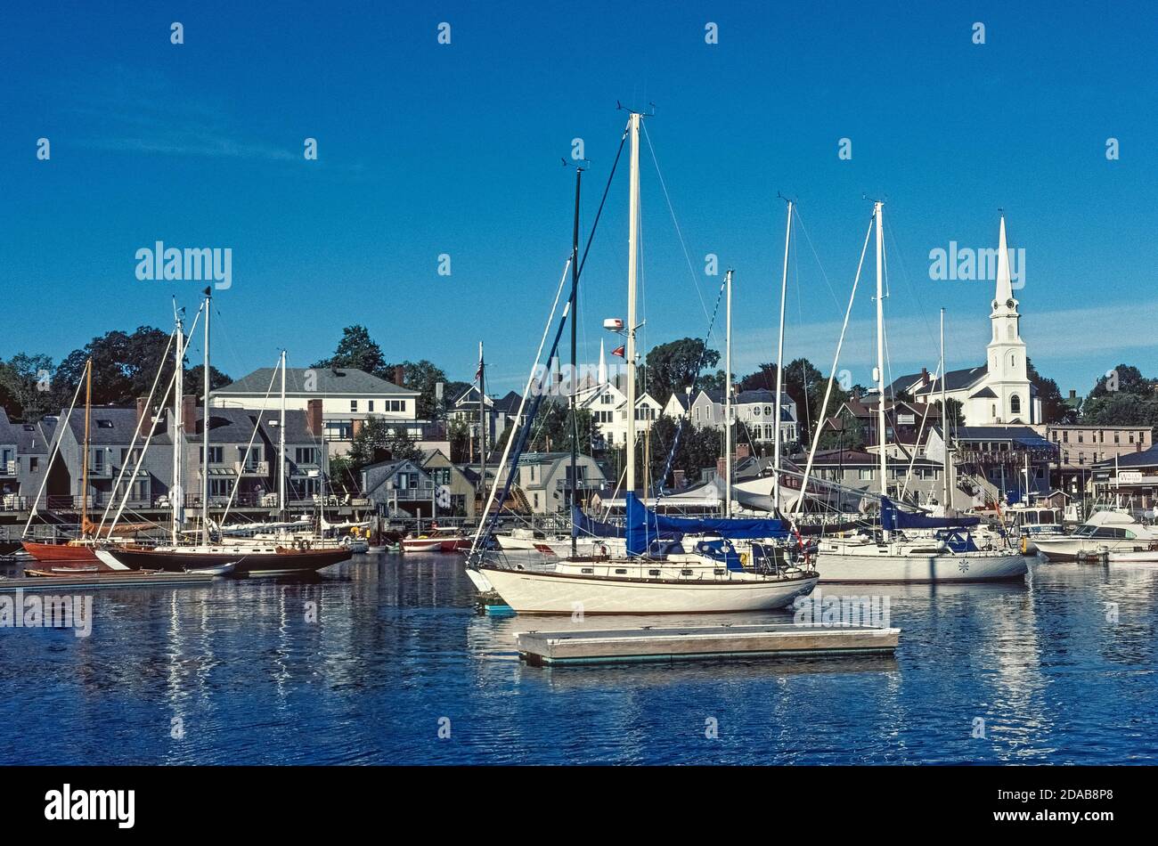 The charming coastal seaport of Camden, Maine, USA, is the iconic New England town with its white steepled church and a harbor full of modern and classic sailboats. These include historic schooners that offer sailing trips in Penobscot Bay and along the northeastern shores on the Atlantic Ocean. Stock Photo