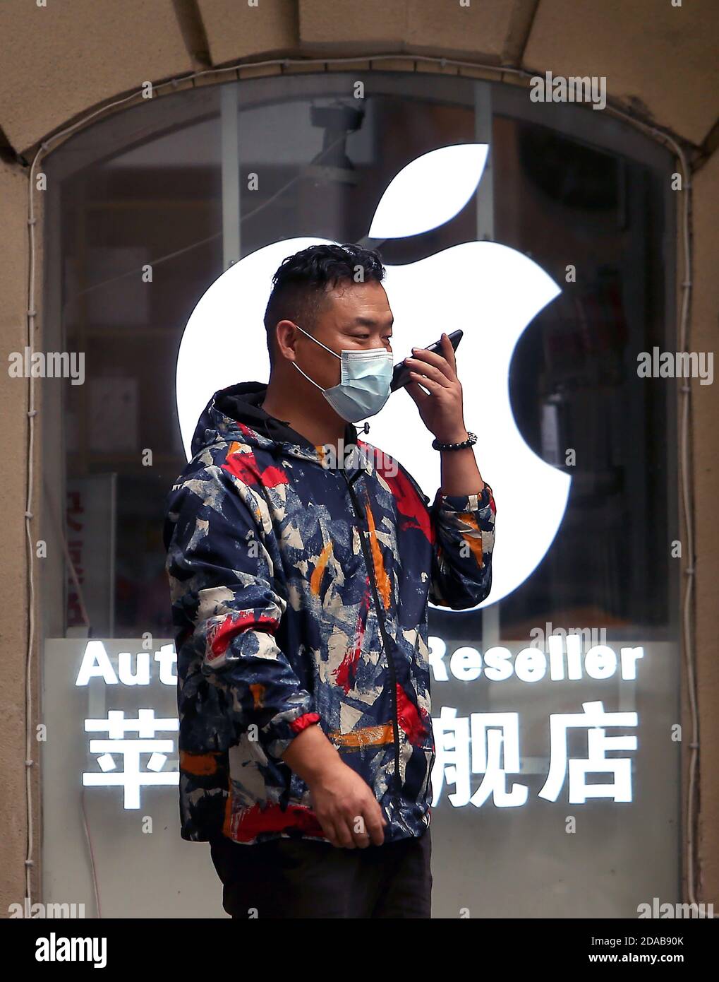 A man walks past an Apple store in Beijing on Wednesday, November 11, 2020.  Apple has revealed it earned $7.9 billion in sales in China, down considerably from last year's $11.1 billion - about a 30% drop in the 4th quarter.  However, Apple's Tim Cook said it still exceeded Apple's expectations.       Photo by Stephen Shaver/UPI Stock Photo