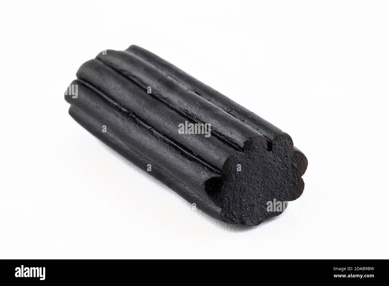 Macro shot of black licorice candy, isolated on a white background