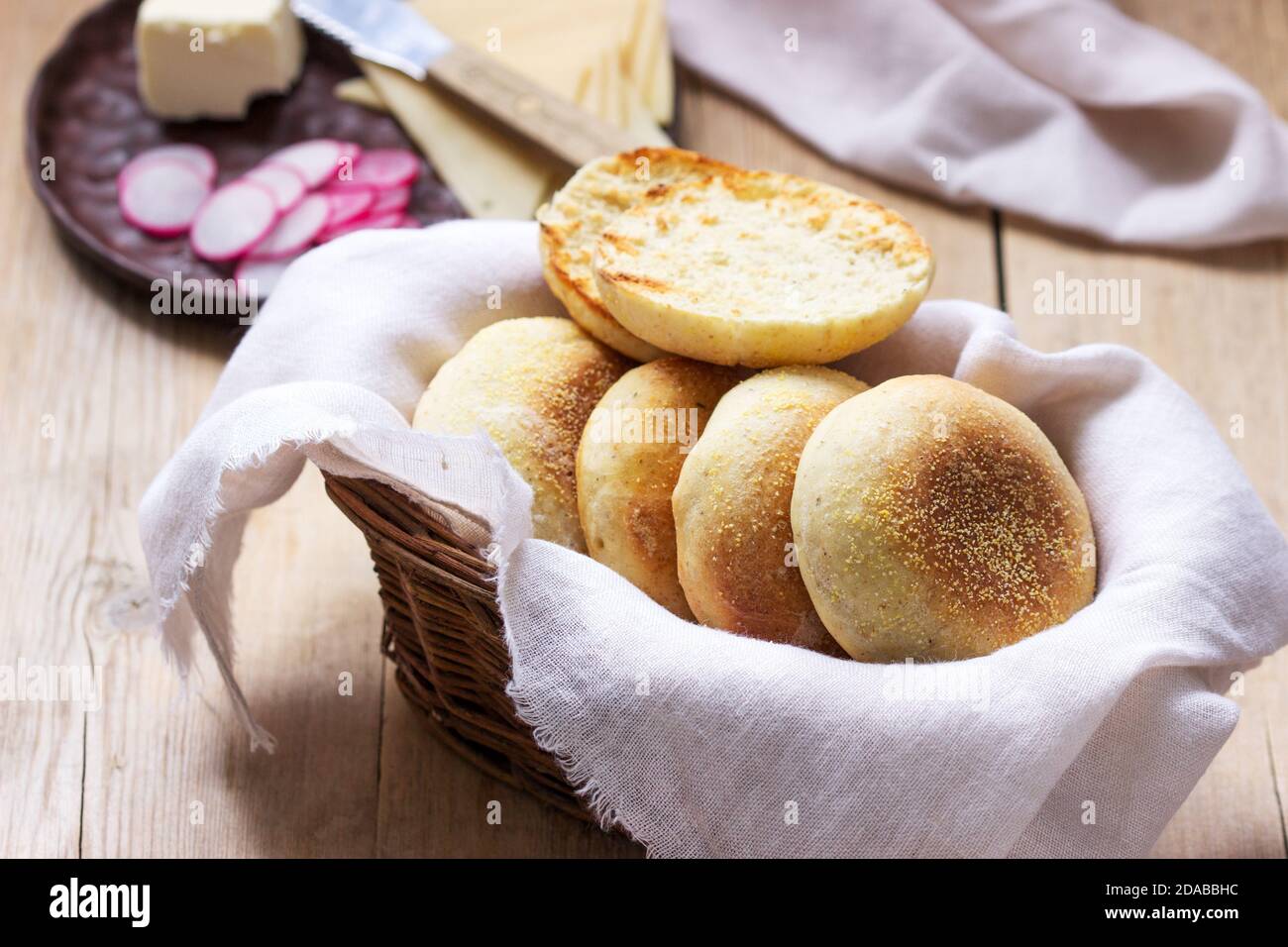 English muffins from whole grain and flax meal, filed with cheese and radish. Rustic style. Stock Photo