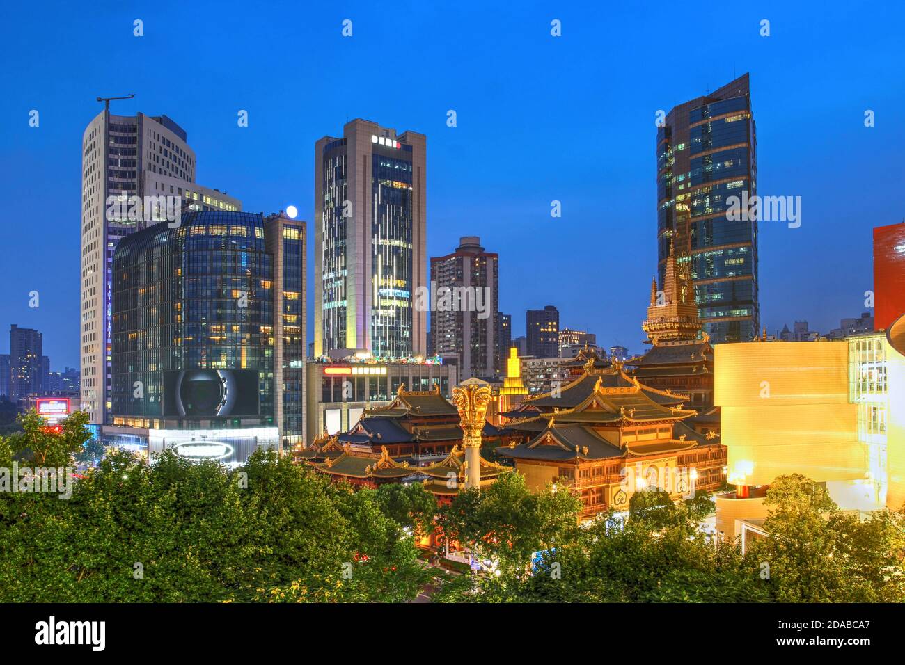 Night view of Shanghai skyline featuring the Jing'an Buddhist Temple and the surrounding skyscrappers in China. Stock Photo