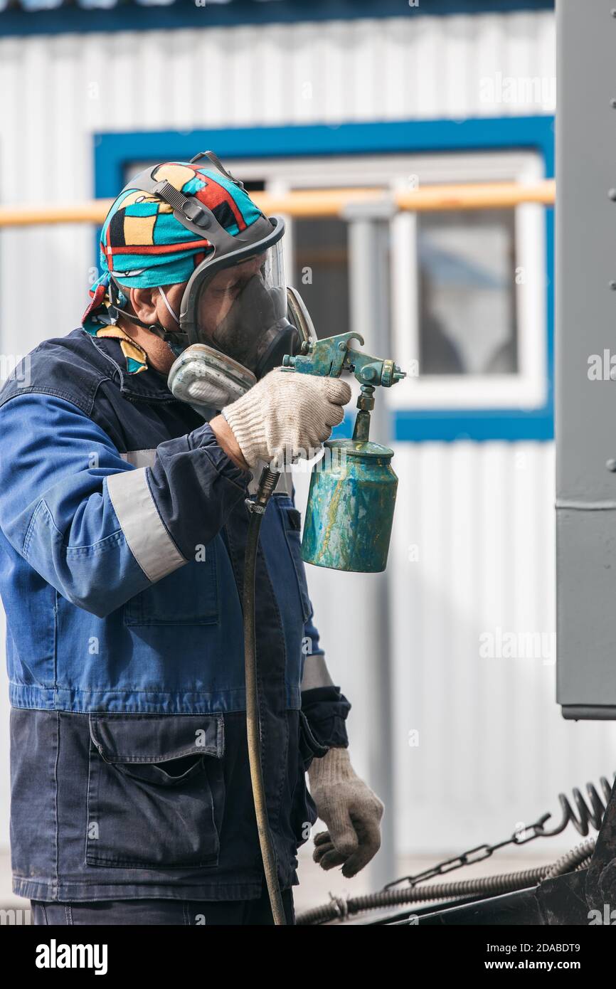 Industrial Work Priming Of Metal Products From The Compressor Gun A Worker In Overalls And A Protective Mask Paints The Body Of A Truck Trailer Or A Stock Photo Alamy