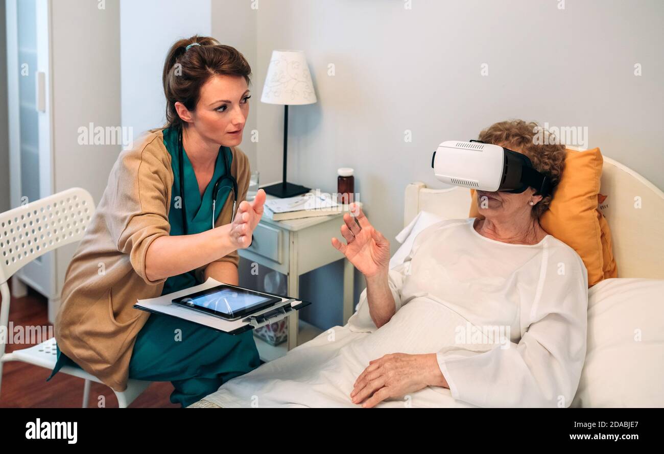 Older patient using virtual reality glasses Stock Photo