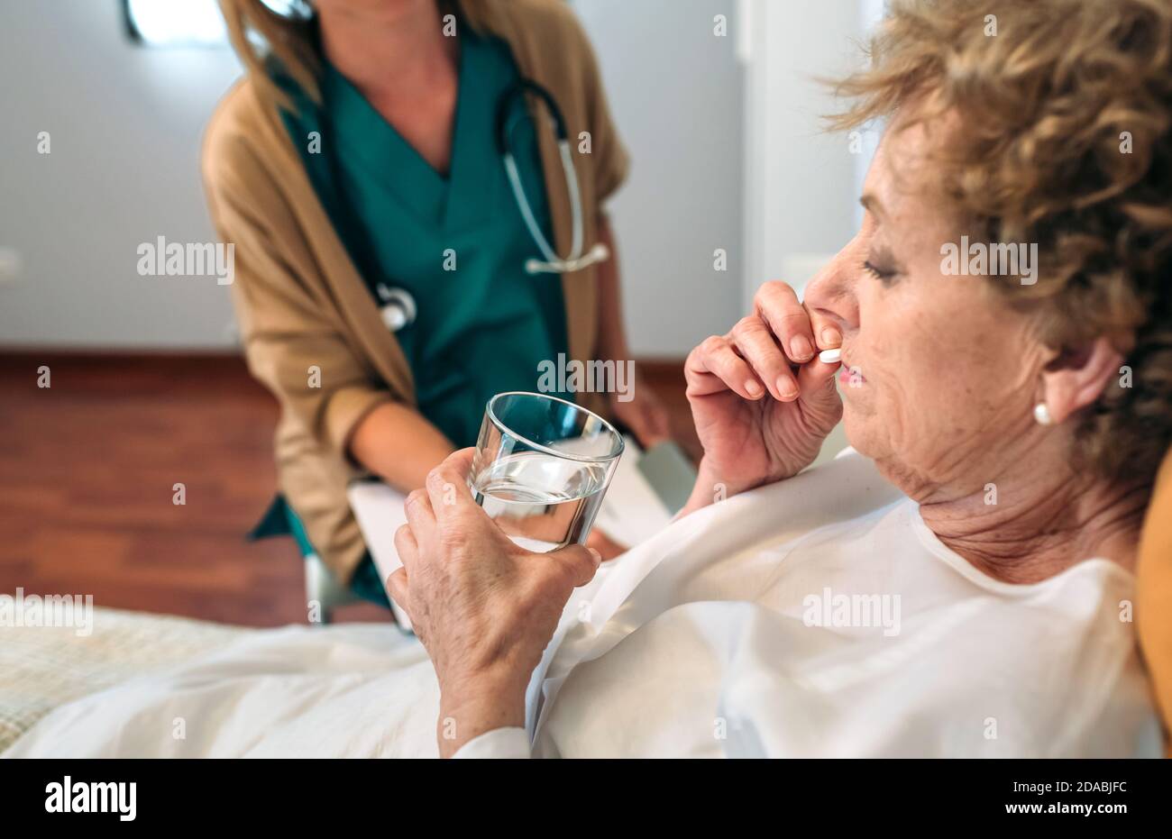 Senior patient taking a pill Stock Photo