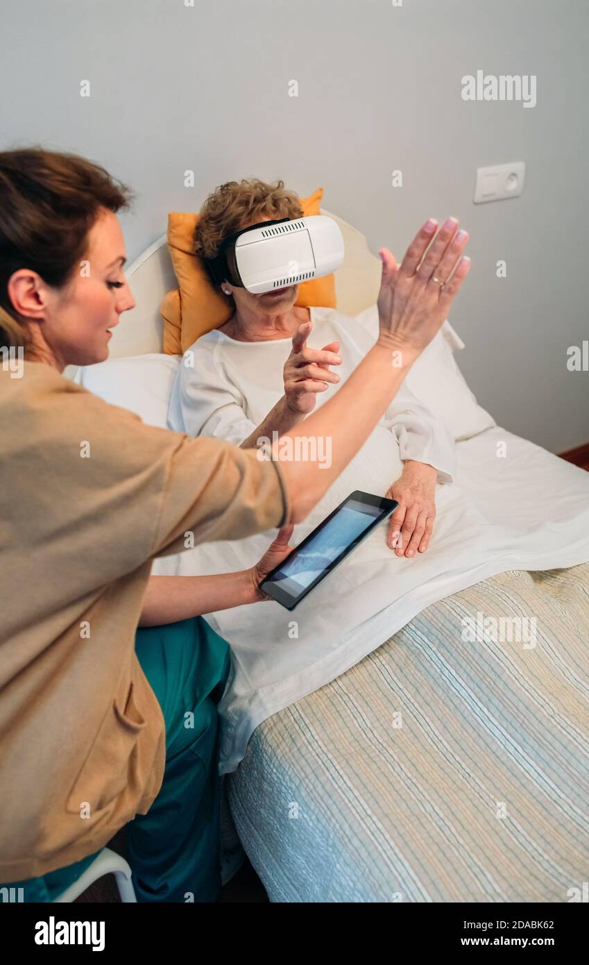 Older patient using virtual reality glasses Stock Photo