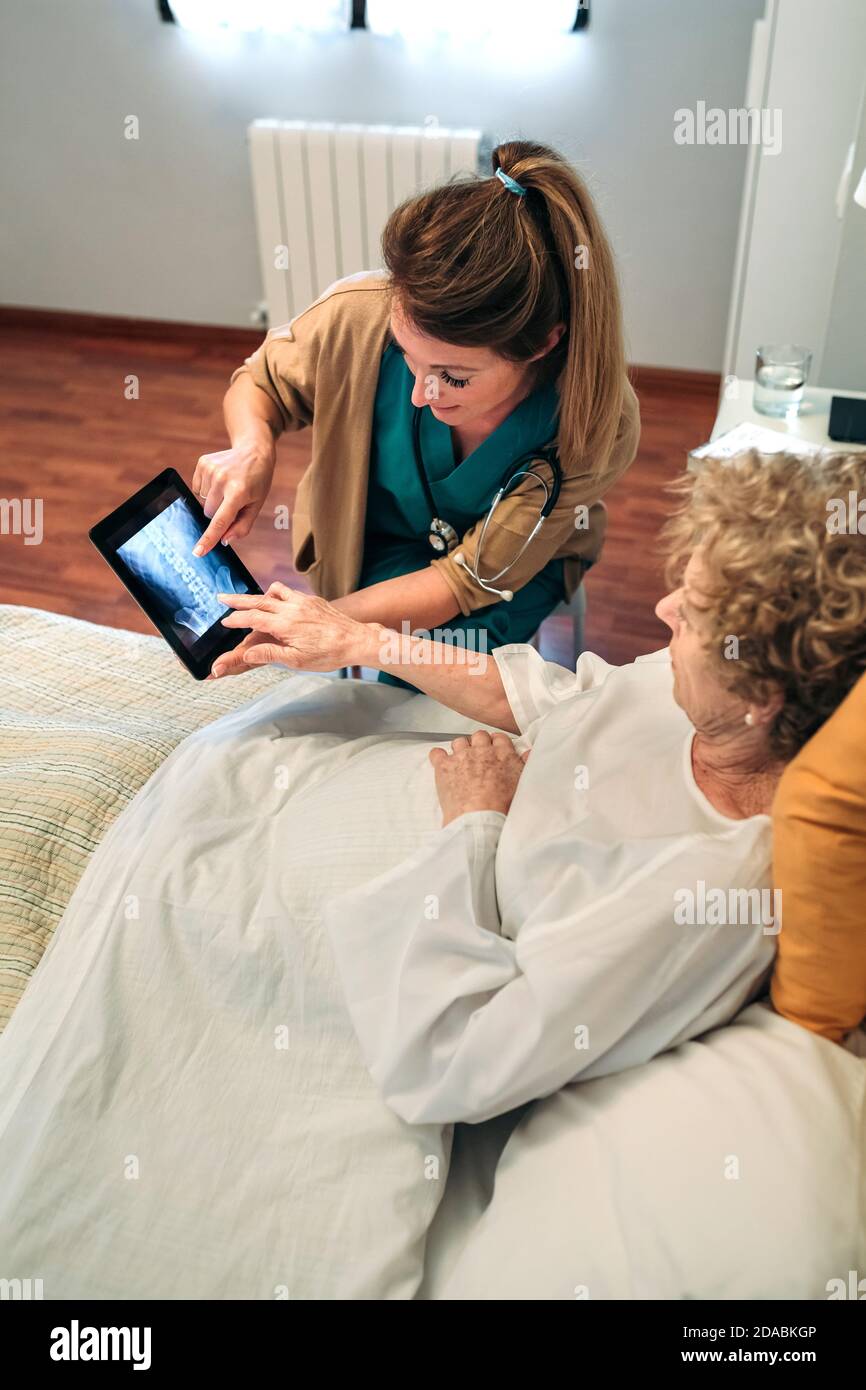 Female doctor showing an x-ray on the tablet Stock Photo