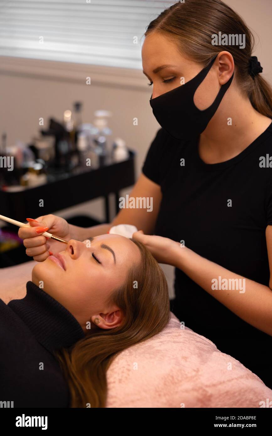 Eyelash extension procedure with master and a client in a beauty salon Stock Photo