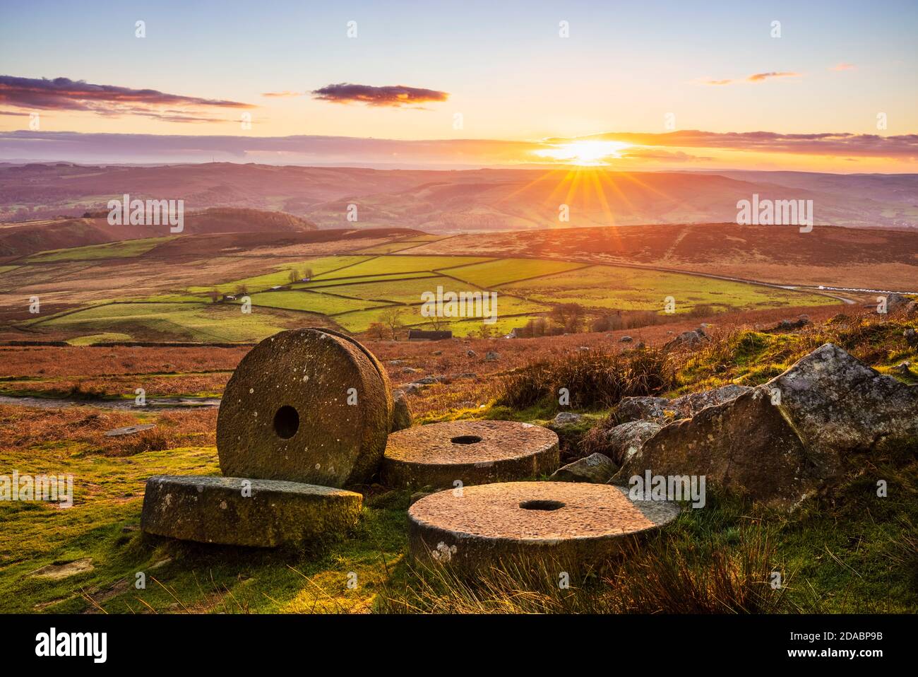 Abandoned Millstones at sunset on Stanage Edge near Hathersage Derbyshire Peak District National Park Derbyshire England UK GB Europe Stock Photo