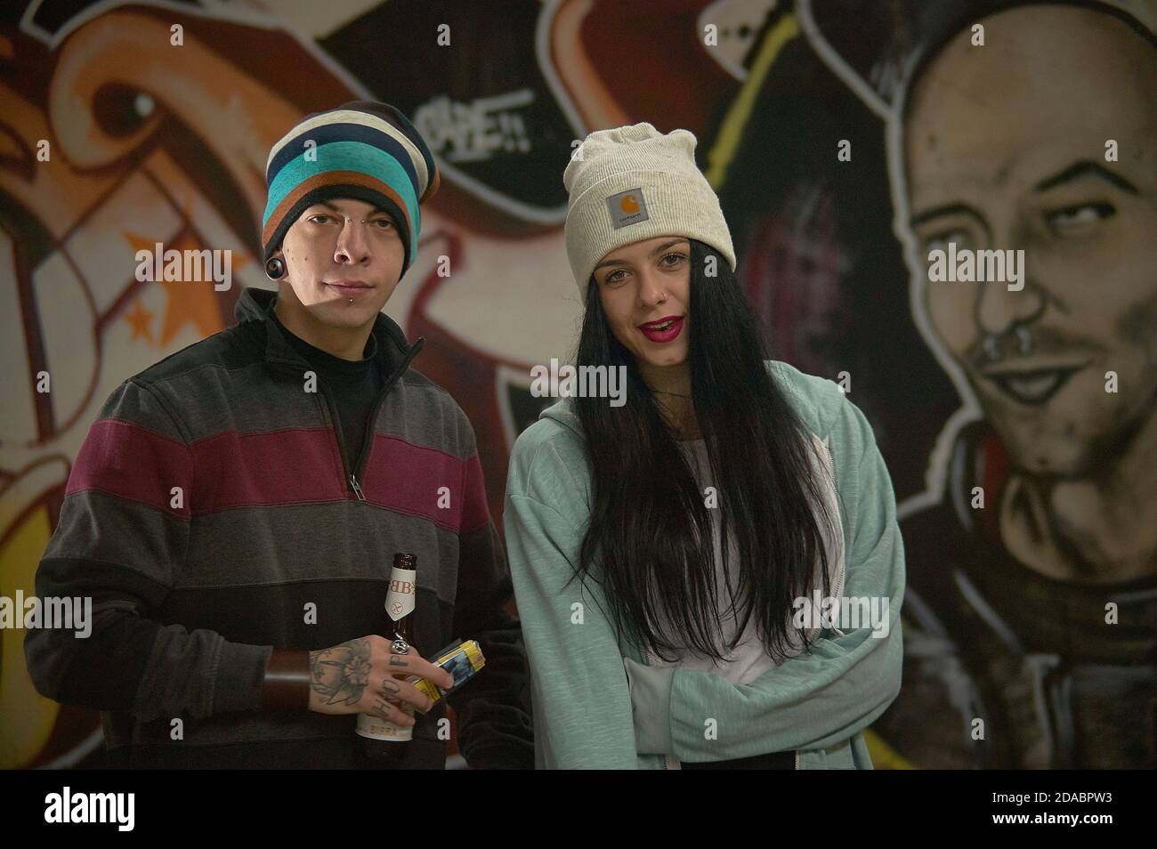 Couple of Bad boy and Bad girl portrayed with a graffiti behind in an