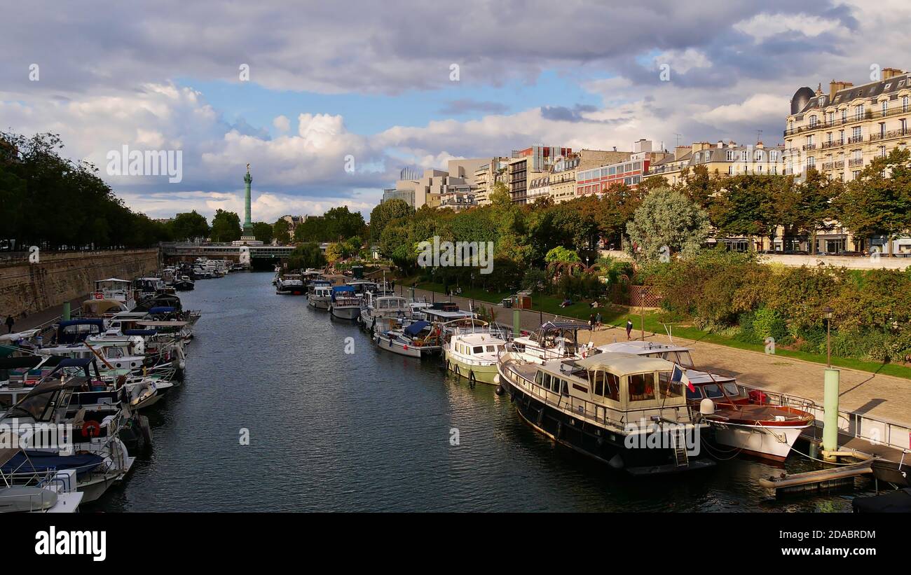 Paris, France - 09/07/2019: Peaceful cityscape with the promenade of Canal Saint-Martin in the east of Paris downtown with docking boats. Stock Photo