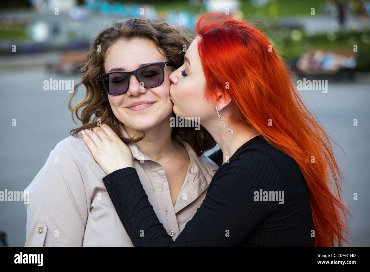 Russia. Moscow 10 July 2020: Best friends meeting each other and gently kissing with great love. Two teenagers having a good mood and smiling facial Stock Photo
