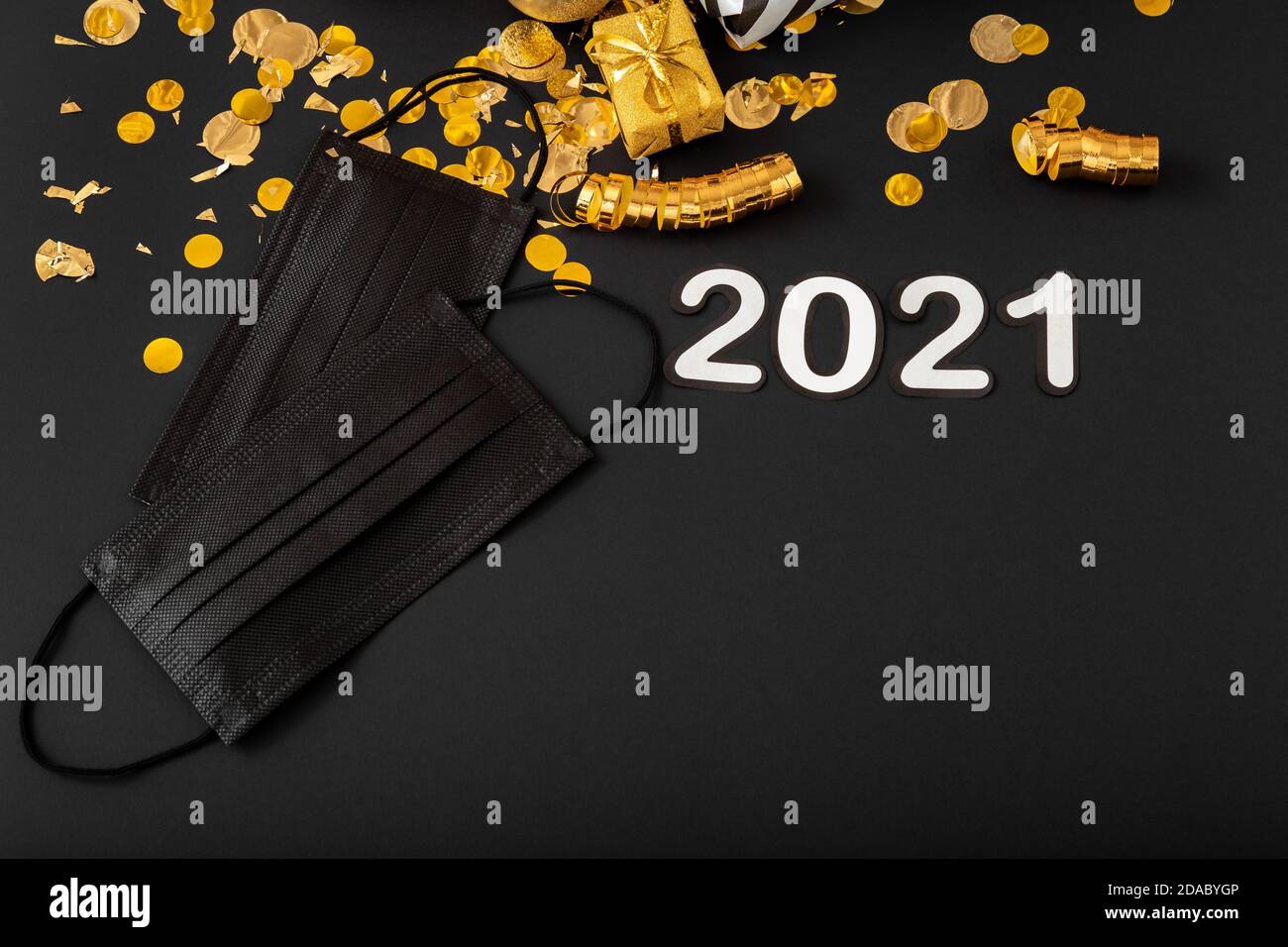 2021 text lettering with black medical face masks, gold Christmas ...