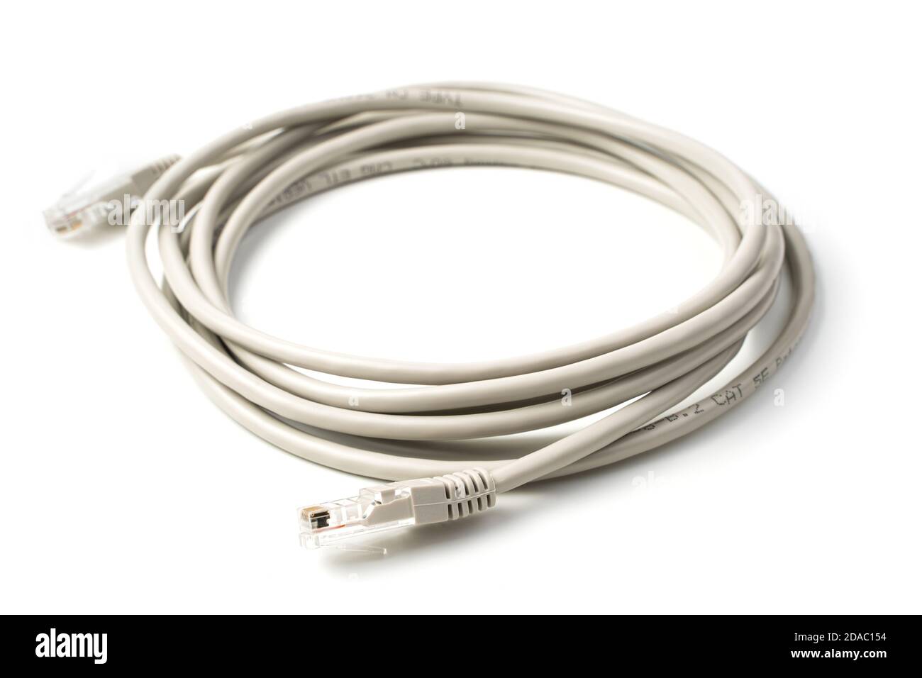 The cable for connecting the computer and router is isolated on a white background Stock Photo