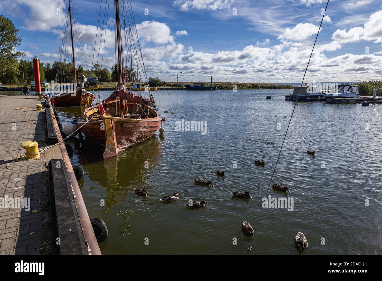 Boats in port in Katy Rybackie village over Bay of Vistula, Pomeranian Voivodeship, in northern Poland Stock Photo