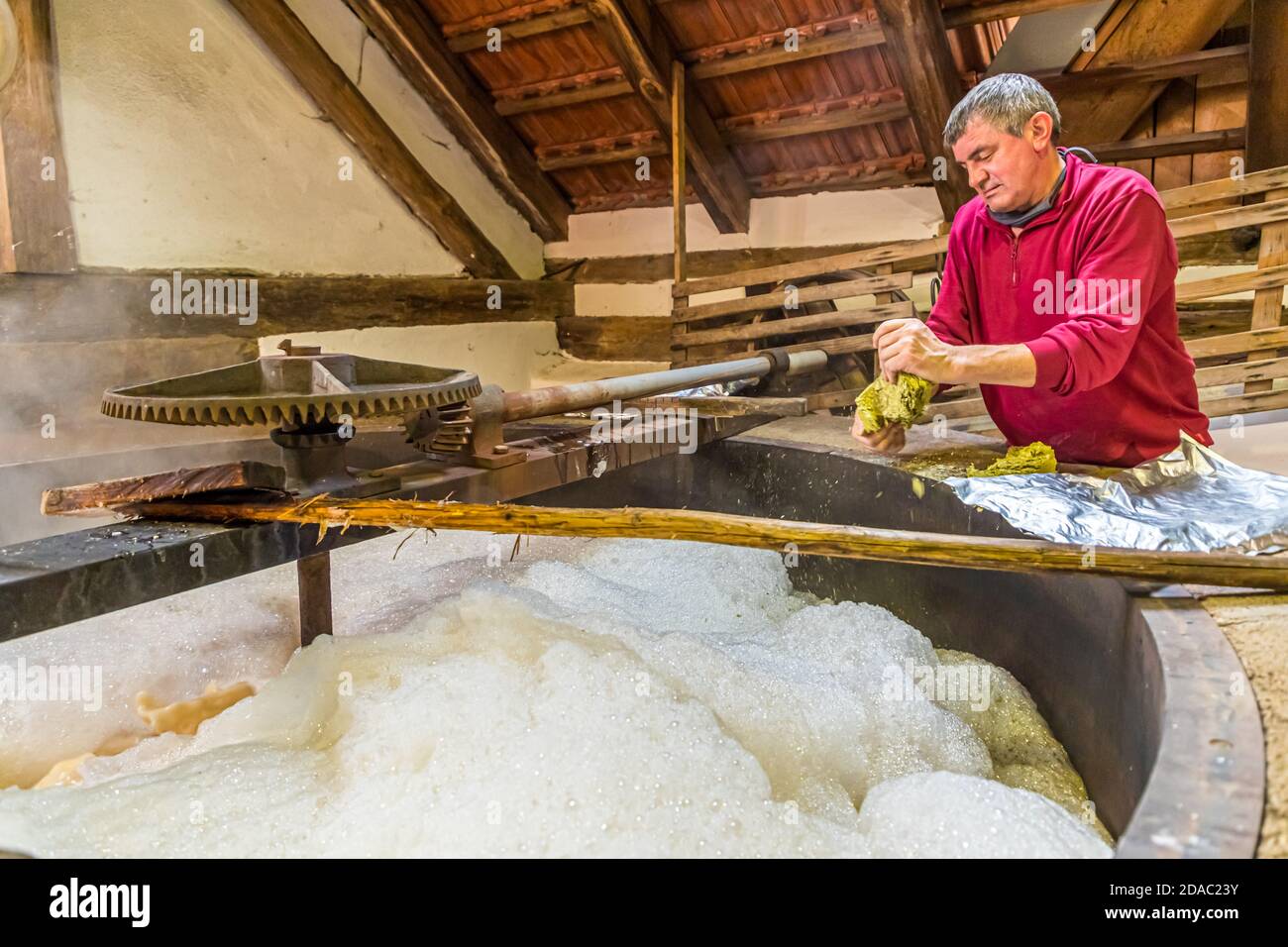 Brewmaster Sepp Neuber adds hops to the original wort of the future Zoigl beer. Traditional Zoigl Brewery in Falkenberg, Germany Stock Photo