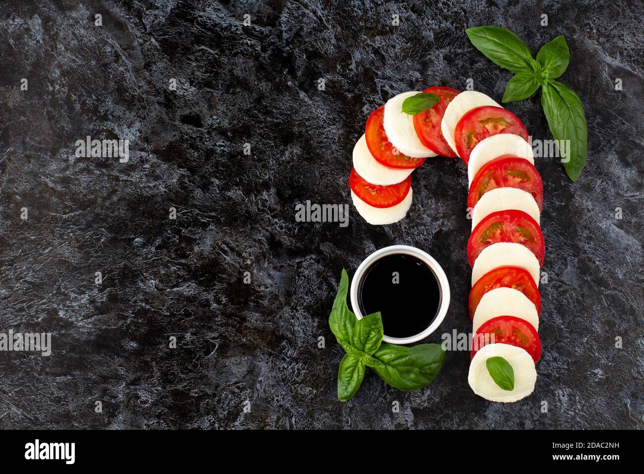 Christmas caprese salad in form of candy cane. Mozzarella and tomato on