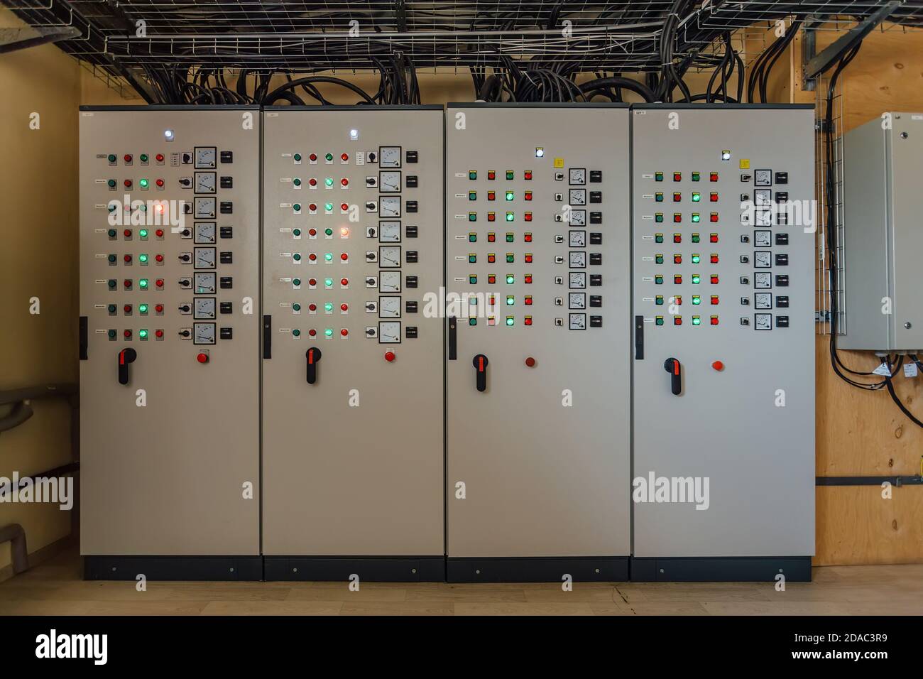 Electrical switchgear cabinets with control panels with indicator lights in factory Stock Photo