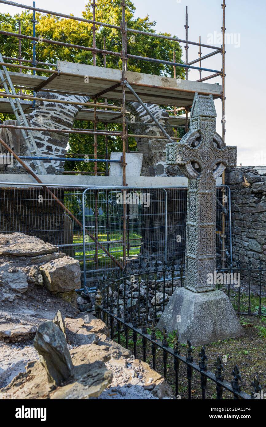 Scaffolding around the arch of a medieval ruin, old church and graveyard in Johnstown, County Kildare, Ireland Stock Photo