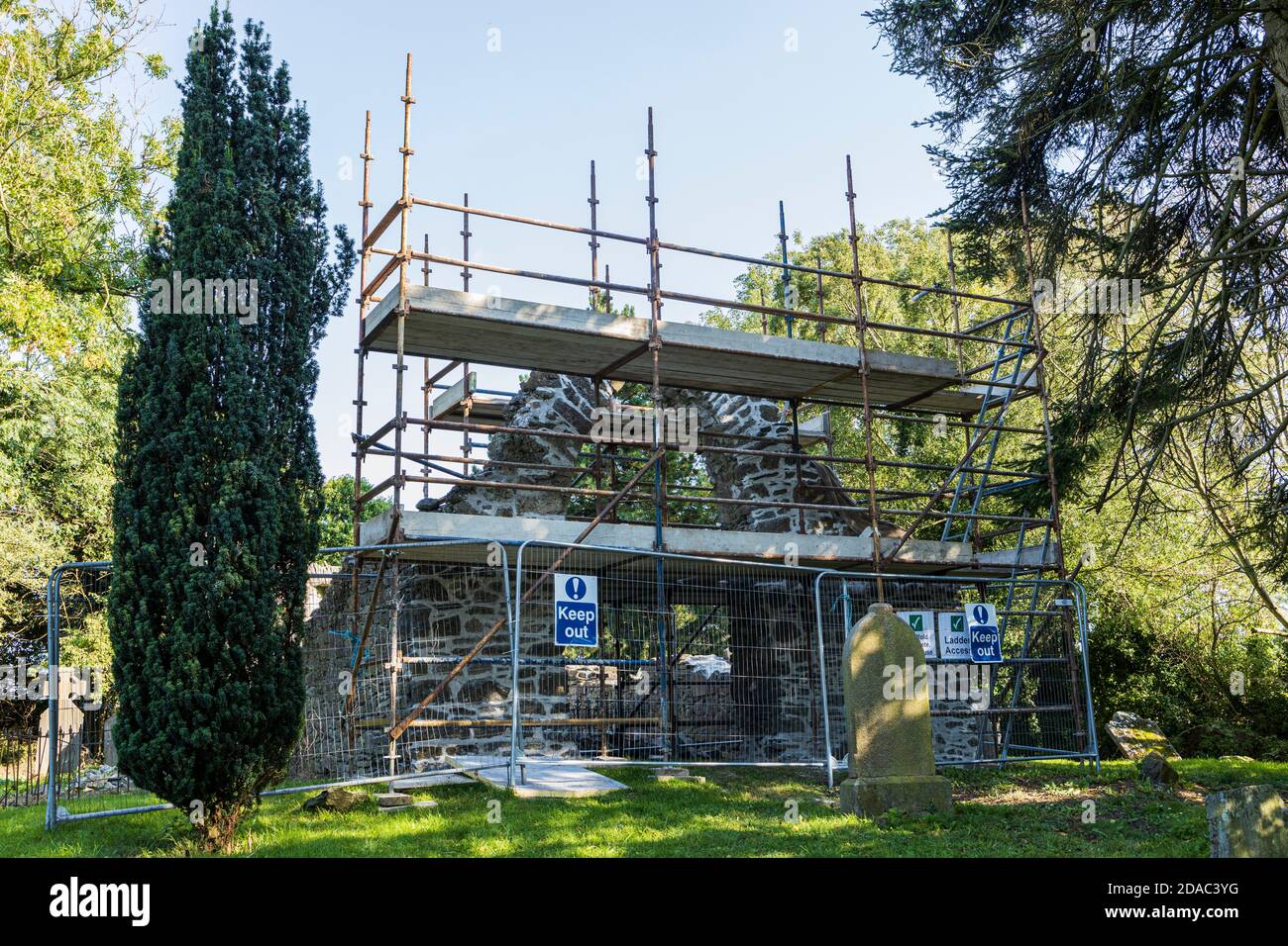 Scaffolding around the arch of a medieval ruin, old church and graveyard in Johnstown, County Kildare, Ireland Stock Photo