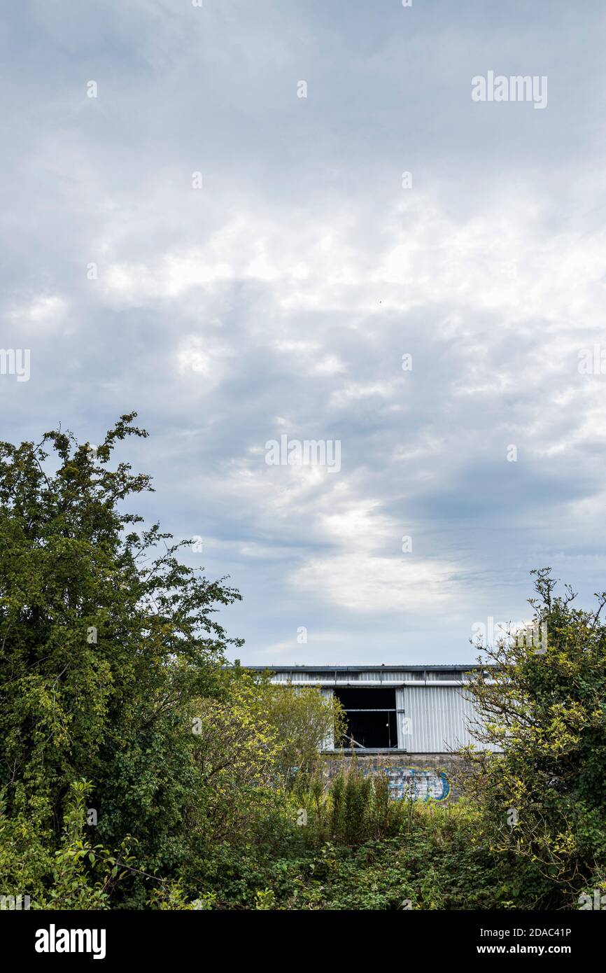 Section of a derelict and burnt out corrugated iron factory building in Naas, County Kildare, Ireland Stock Photo