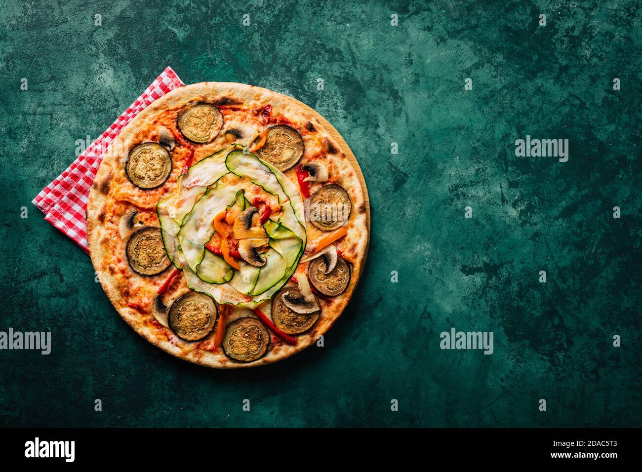 Vegetarian vegetable pizza on a green background. Copspace Stock Photo