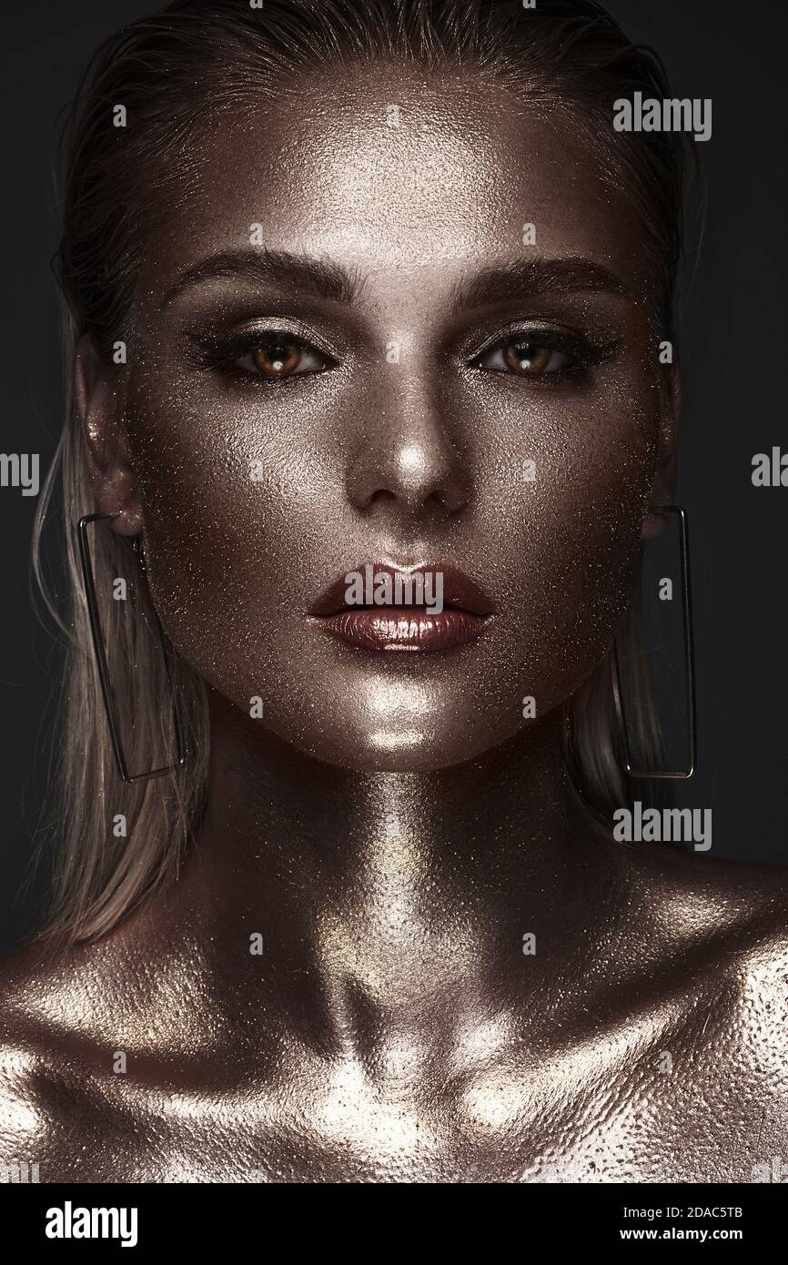 Portrait of beautiful woman with art space makeup on her face and body