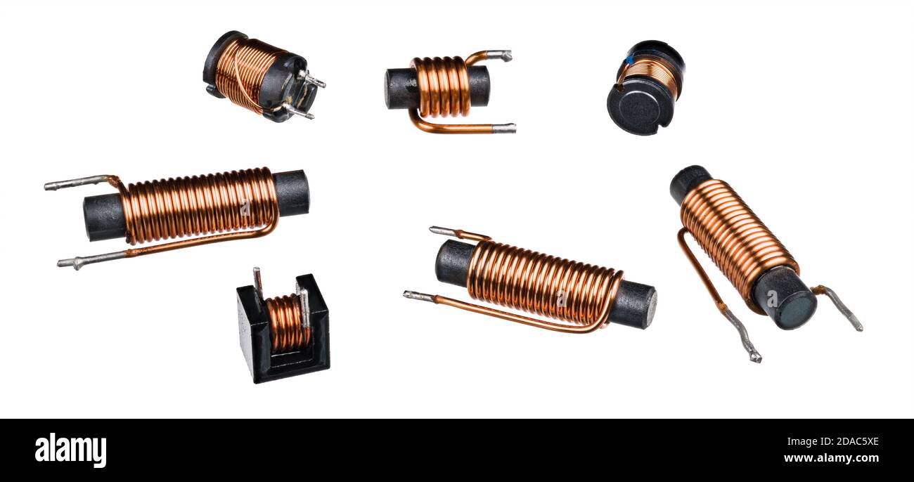 Set of solenoid induction coils with black ferrite core isolated on white background. Close-up of cylindric inductors with helical copper wire winding. Stock Photo