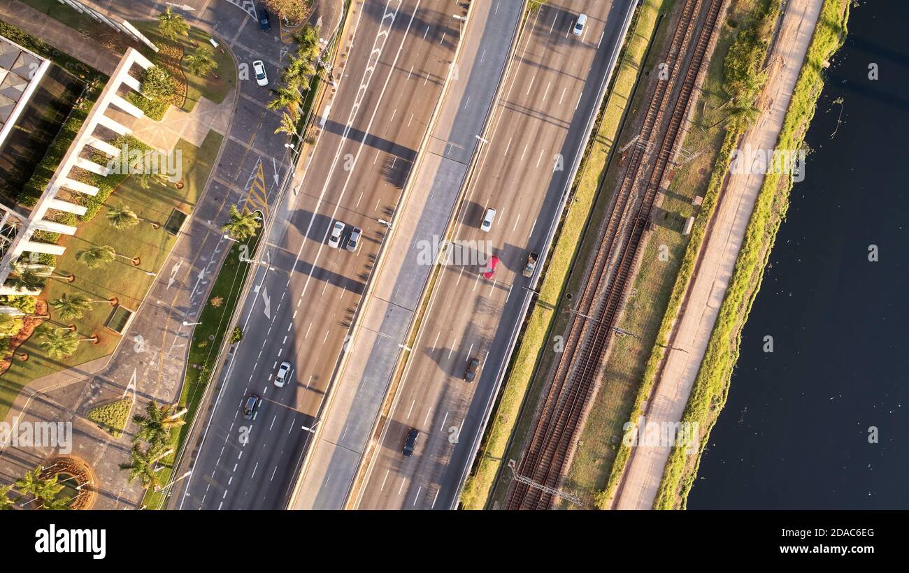 Top aerial view of Marginal Pinheiros expressway and Pinheiros river in Sao Paulo city, Brazil. Traffic with few cars near Estaiada Bridge (Ponte Esta Stock Photo