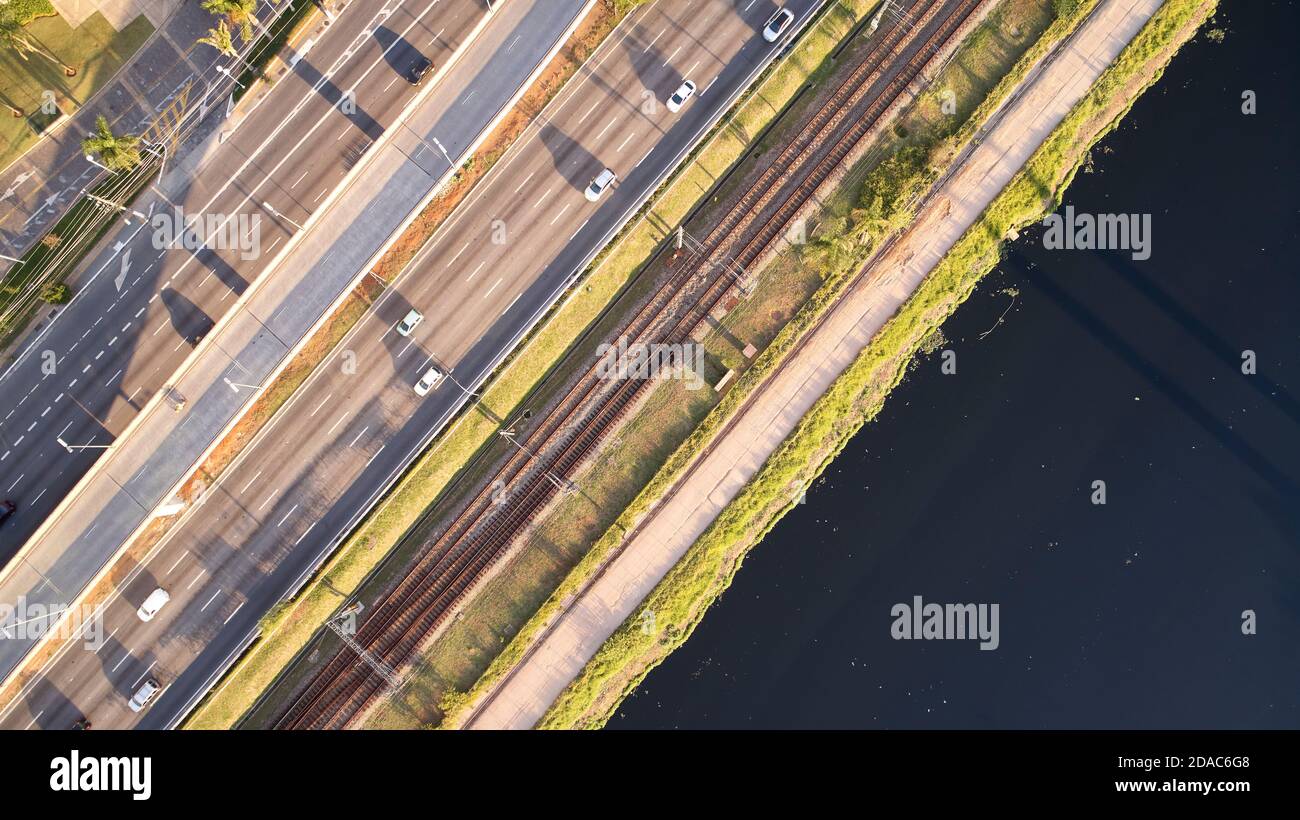 Top aerial view of Marginal Pinheiros expressway and Pinheiros river in Sao Paulo city, Brazil. Traffic with few cars near Estaiada Bridge (Ponte Esta Stock Photo