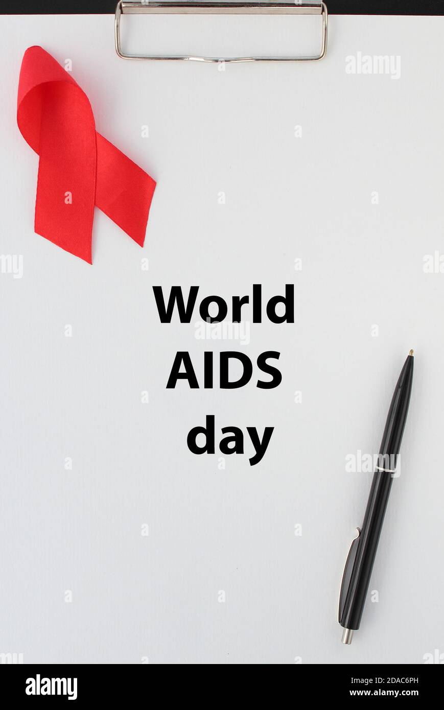 The red ribbon and title World AIDS day on white sheet of paper Stock Photo