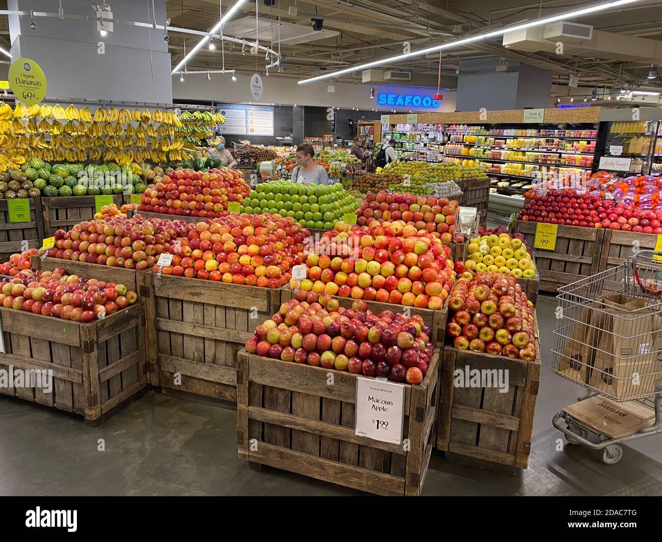 Fresh autumn apples on display by the bushel at Whole Foods Market in Manhattan, New York City. Stock Photo