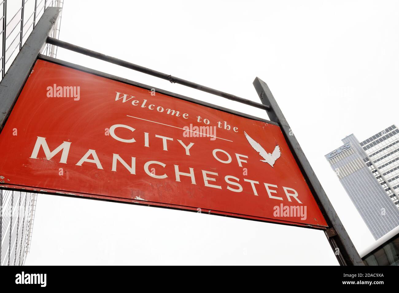 Road sign proclaiming: Welcome to the CITY OF MANCHESTER. The 118m tall CIS Tower building lies in the distance. Stock Photo