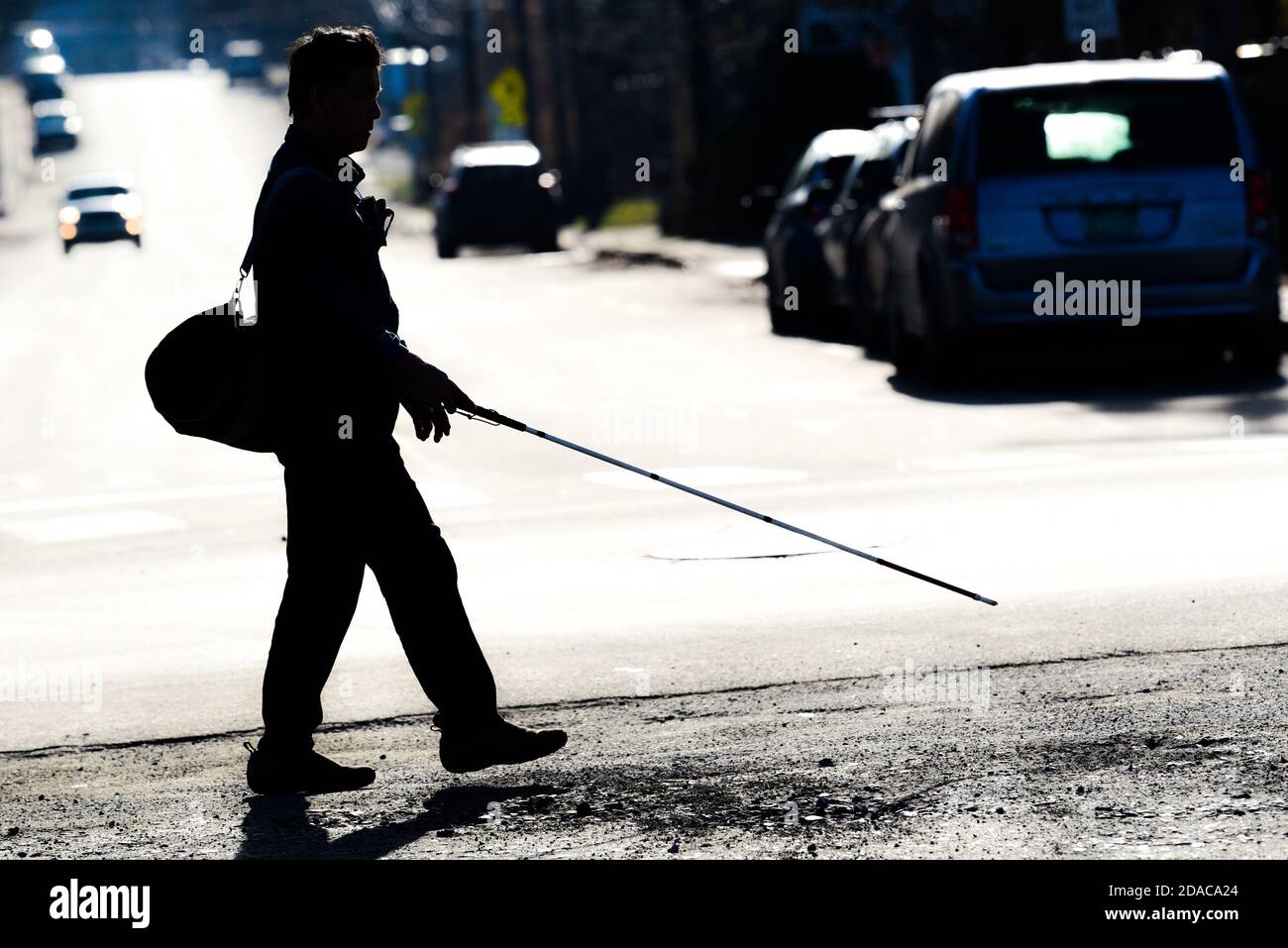 Blind man walking with cane hi-res stock photography and images - Alamy